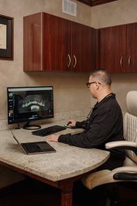 Serenity Advanced Dentistry dentist looking at dental x-rays benefits