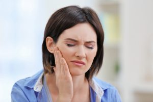 Young woman with tooth pain